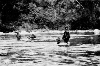 Campas Family wading across a Stream.