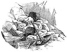 pile of rocks, wheelbarrow and pick-axe