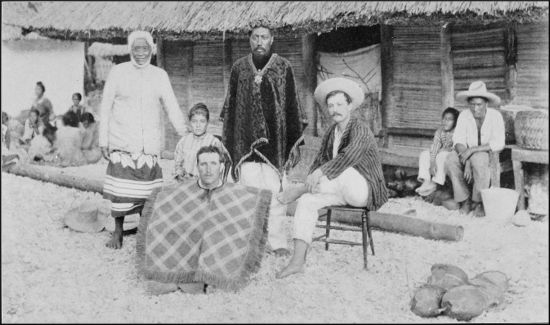 The King of Manihiki in the centre, with the Island Judge on his right and Tin Jack, seated, on his left. The man squatting in the foreground is one of the beach-combers