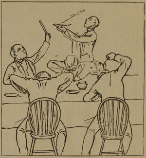 Four men at table, digging enthusiastically into their meal and gesturing to the waiter