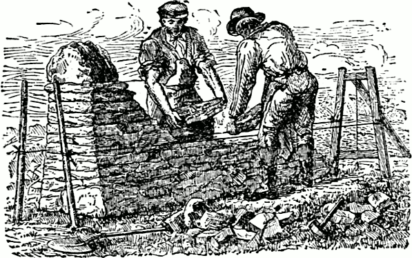 2 masons building a stone fence